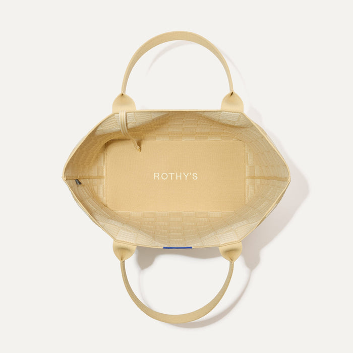 The Lightweight Tote in Checker Sand shown open from the top, with interior visible.