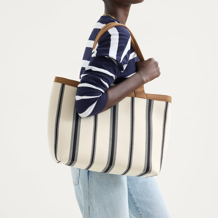 hover | Model holding The Lightweight Zip Tote in Coastline.