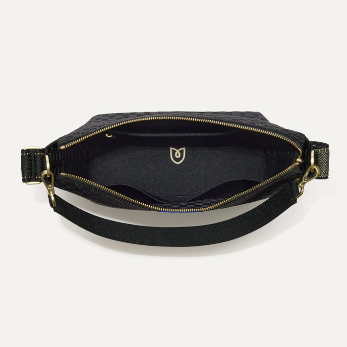 The Mini Zip Bucket in Black Sand shown from the top down, with zipper open and interior exposed.