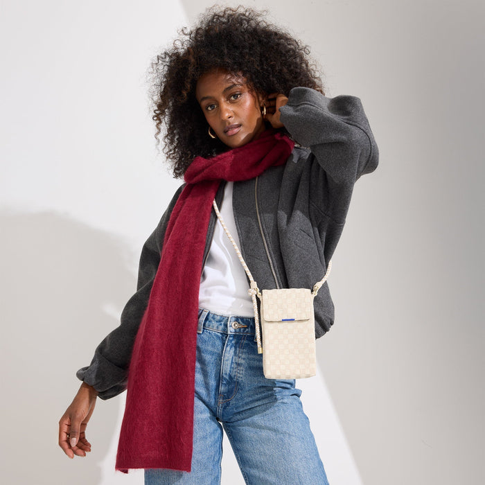 hover | Model wearing The Phone Crossbody in White Sand.