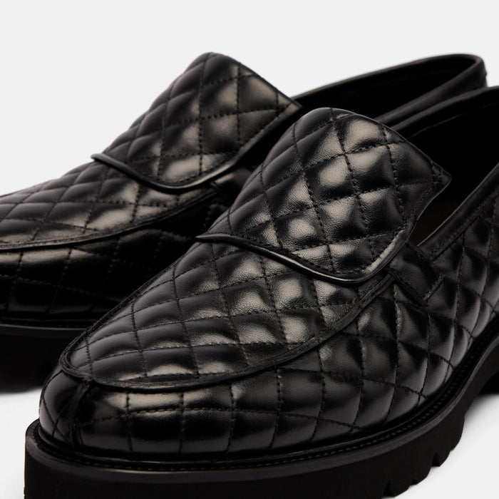 The Pitch Black Quilted Leather Lug Penny Loafers