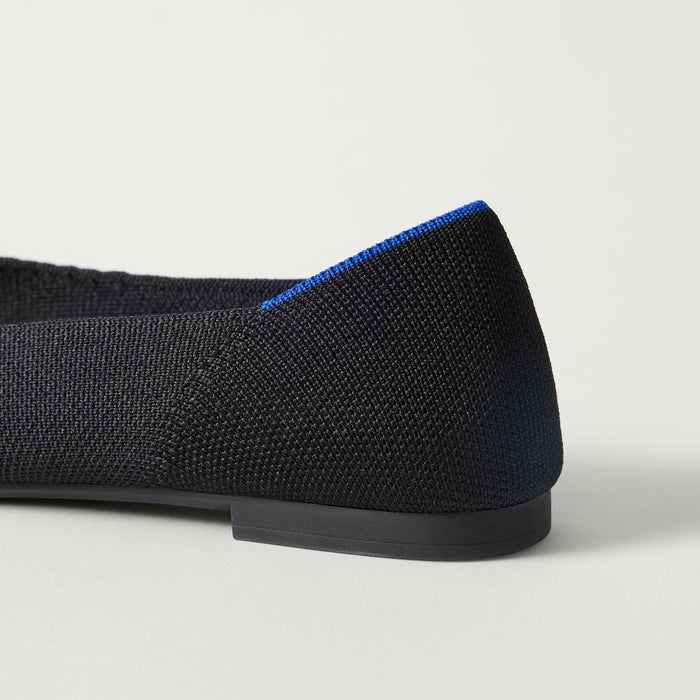 Close up of the heel of The Point III in Black, with Rothy's signature blue halo.