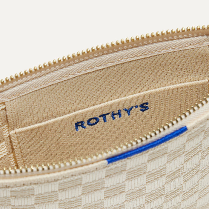 A closeup of The Wallet Wristlet in Vanilla Basketweave, focusing on the inner card slip.
