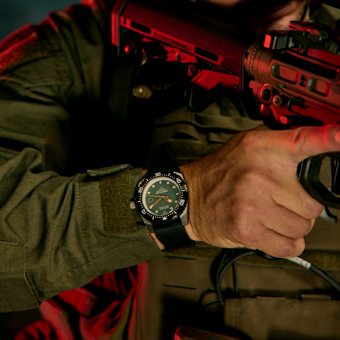 Shot of Kore Essentials Timberland Watch on Mans Wrist as He Aims