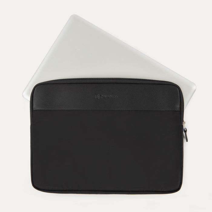 Travelpro® Essentials™ 13"/14" Laptop Sleeve in Black, shown with a laptop partially inserted to highlight its slim, protective fit, featuring a leather-accented top panel and secure side zipper closure.