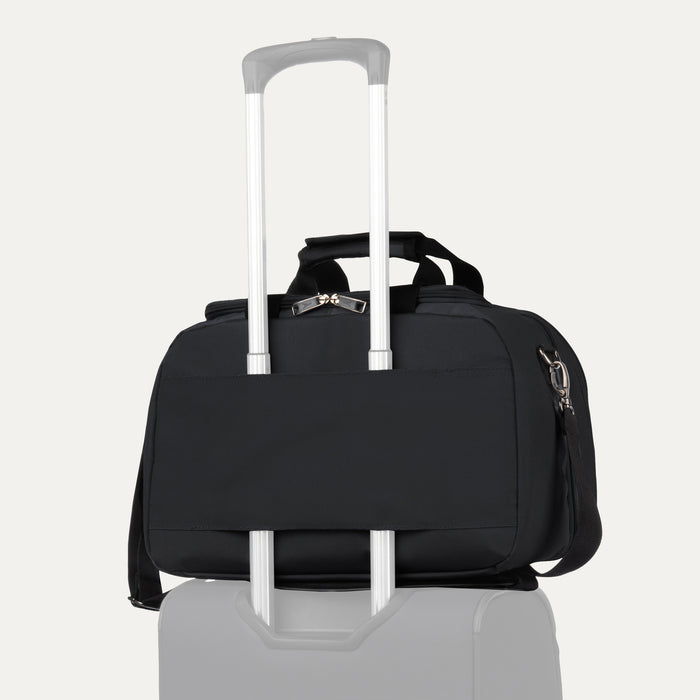 Travelpro® Essentials™ 2-in-1 Travel Tote & Cooler in Black, shown securely attached to a rolling suitcase handle using its rear strap, demonstrating its convenient stacking ability