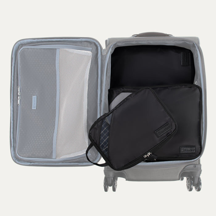 Top view of Open Travelpro Essentials 3 Pack Expandable/Compressible Packing Cube Set (Medium, Large, Extra Large) in BLACK, with Extra Large and Large inside suitcase and Medium resting on top.