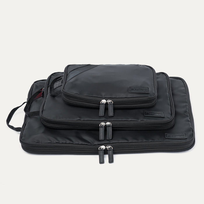 Front view of stacked Travelpro Essentials 3 Pack Expandable/Compressible Packing Cube Set (Medium, Large, Extra Large) in BLACK, showing dual zipper closures.