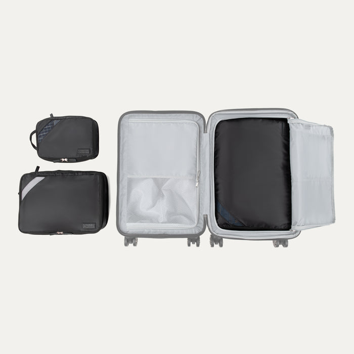 Top view of Travelpro Essentials 3 Pack Expandable/Compressible Packing Cube Set (M/L/XL) in BLACK, with XL packed in suitcase and M and L outside.