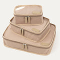 Angled front view of Travelpro Essentials 3 Pack Packing Cube Set (S/M/L) in KHAKI, stacked to show dual-zip closures and accent panels.