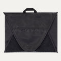 A black Travelpro Essentials Garment Packing Folder, designed to organize and protect clothing during travel.