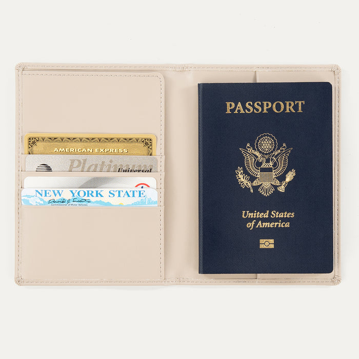Open khaki Travelpro® leather passport cover with a passport on the right side and multiple cards organized in slots on the left side.