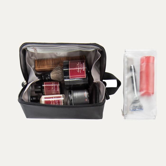 A toiletry organizer bag open, displaying various compartments and pockets filled with grooming supplies, with an exterior zippered pocket containing additional travel-sized items.