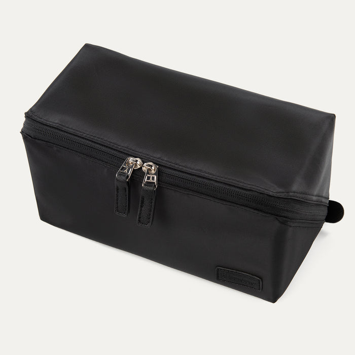 Front angled view of the Travelpro® MaxAccess Cubes™ Toiletry Organizer in black with dual zippers and a structured rectangular design.