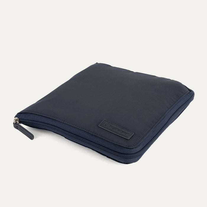 Folded view of the Travelpro Essentials SparePack Foldable Duffel 2.0 in Navy, showing the bag packed down into its own compact, zippered storage pouch for easy transport when not in use.