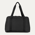 Front view of the Travelpro Essentials SparePack Foldable Duffel 2.0 in Black, showcasing the lightweight, abrasion-resistant fabric, durable top carry handles, and the QuickSlip front pocket for convenient on-the-go storage.