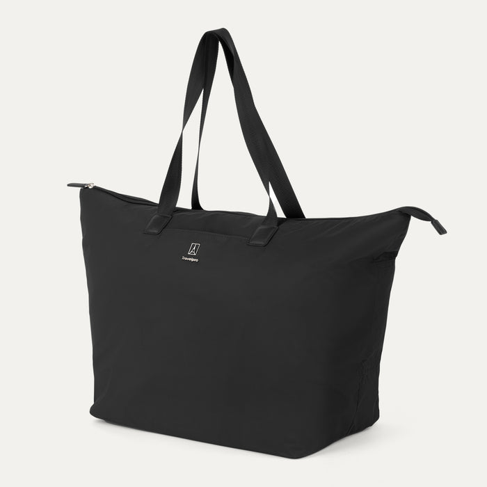 Angled view of the Travelpro Essentials SparePack Foldable Tote 2.0 in Black, showcasing the tote's silhouette, spacious main compartment, and durable carry straps.