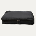 A black Travelpro Essentials XL expandable/compressible packing cube with a zipper.