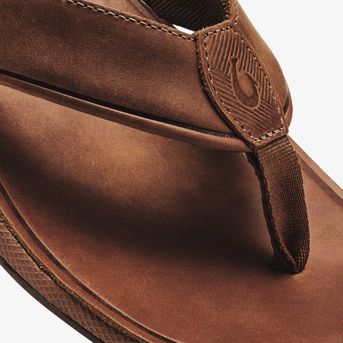 Brown suede thong sandal with embroidered toe post and textured sole.