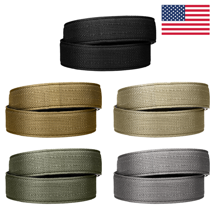 A collection of Kore Essentials USA-made tactical gun belt straps. Visible are five gun belt straps: black, coyote, ranger green, tan 499 and gray.